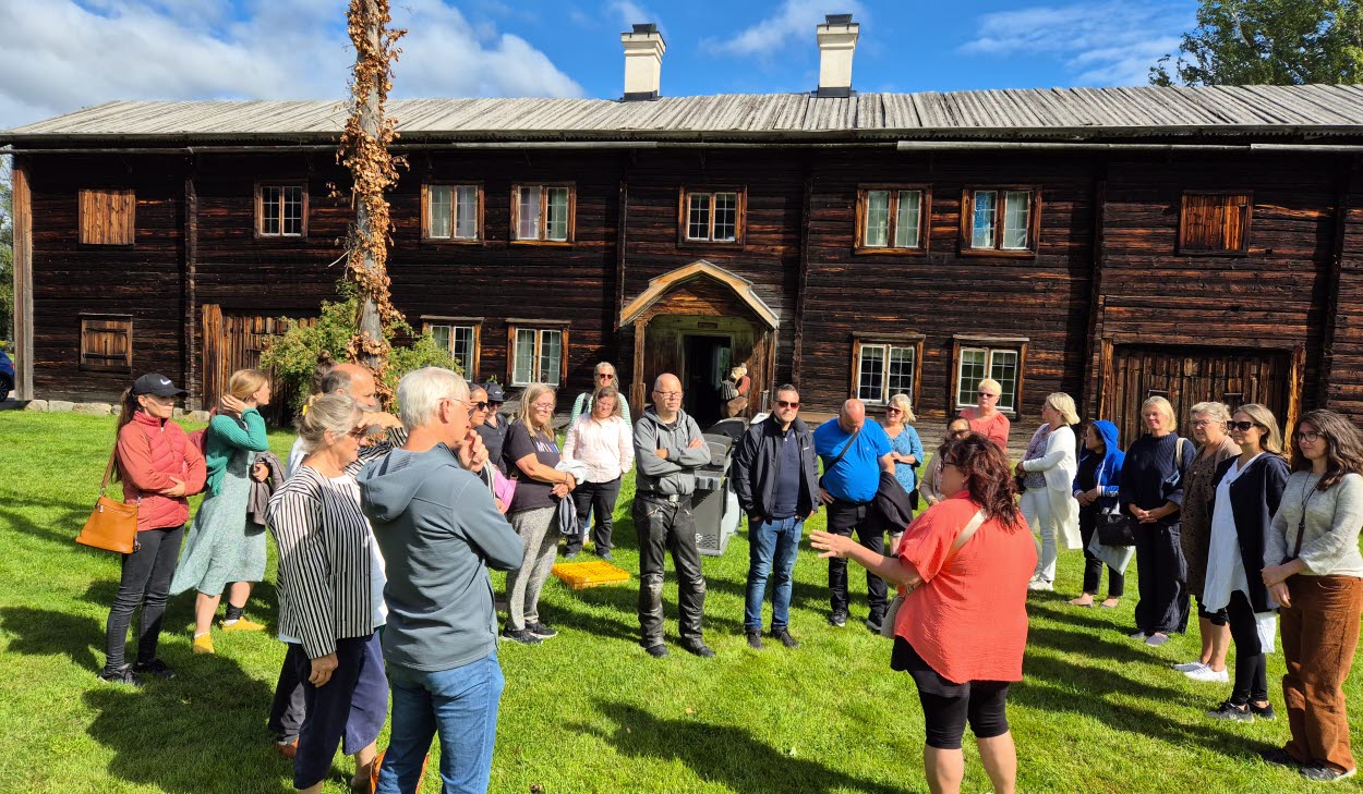 Gruppbild på människor vid en Hälsingegård